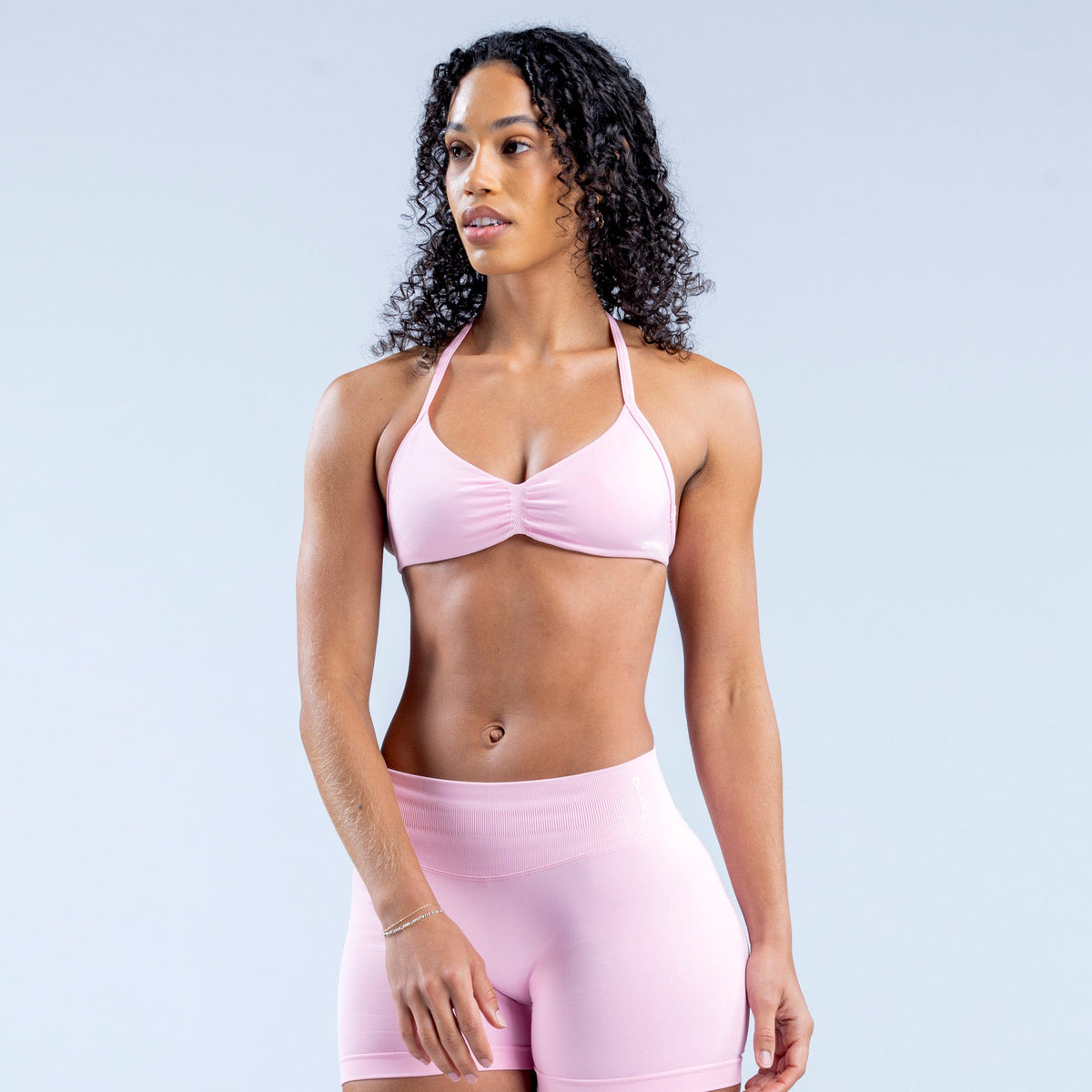 Light pink strappy bra with ruched center and thin shoulder straps