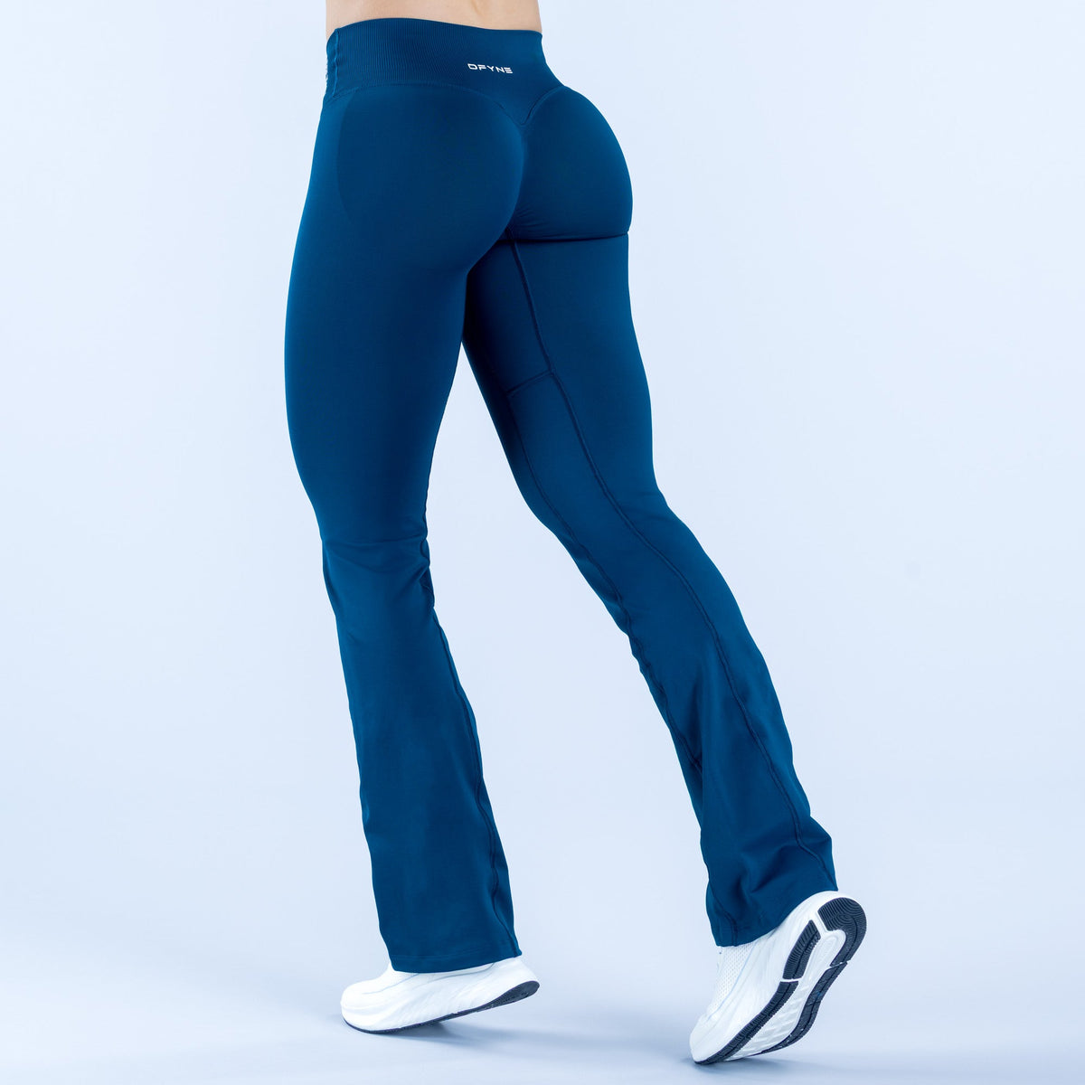 Blue flare leggings, back view, with smooth fabric and stitched panel seams